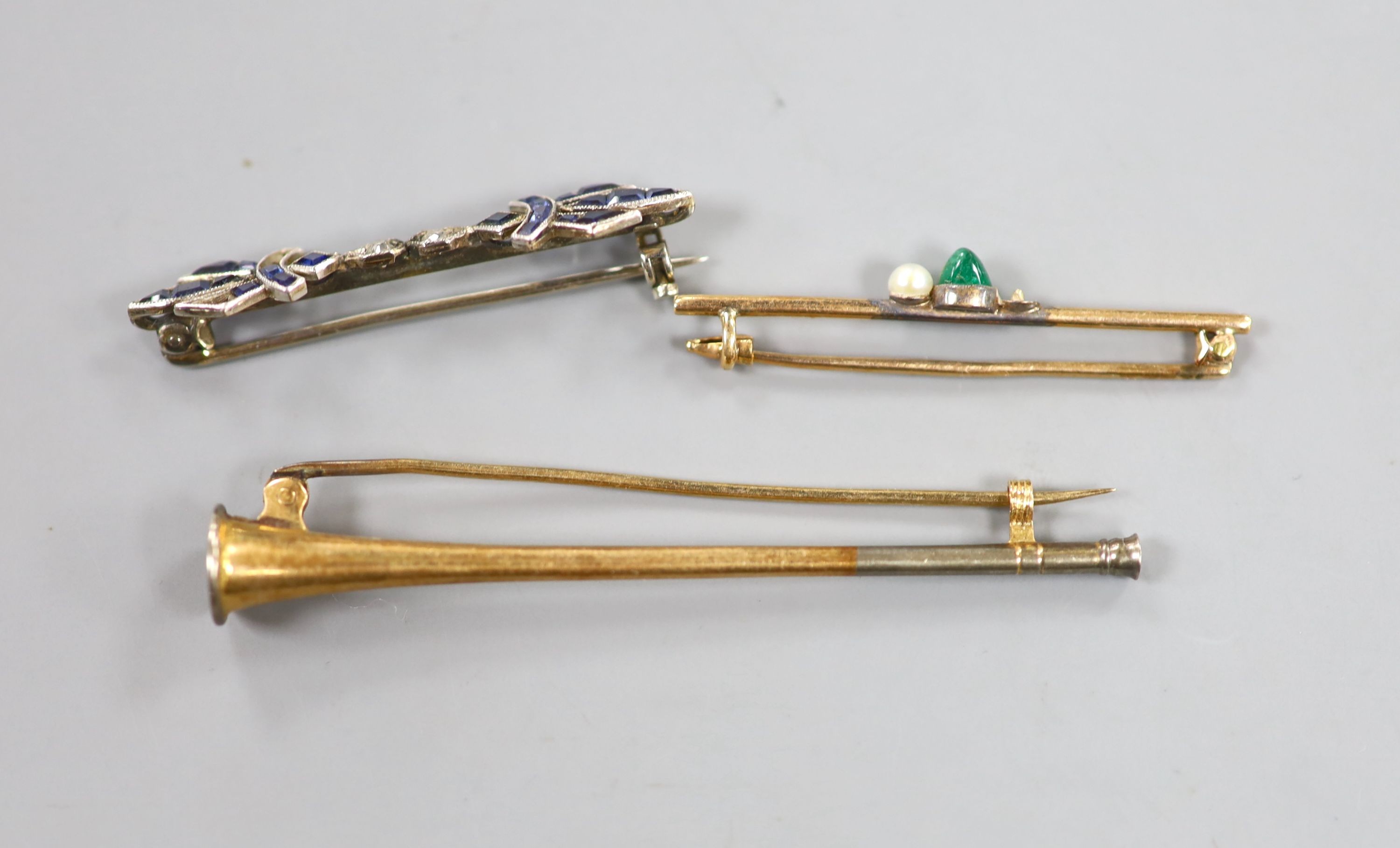 A 1920's white metal synthetic sapphire and diamond set bar brooch(stones missing), 37mm and two other bar brooches including horn and emerald and pearl(stone missing), gross weight 6.8 grams.